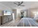Bright bedroom with a large dresser, television, and a ceiling fan with a light at 5624 Palmer Cir # 206, Bradenton, FL 34211