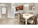 Open dining area features a white table, seating for four, and access to the kitchen at 5624 Palmer Cir # 206, Bradenton, FL 34211