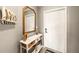 Stylish entryway with a console table, mirror, and coastal decor accents at 5624 Palmer Cir # 206, Bradenton, FL 34211