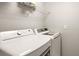Laundry room with a modern washer and dryer and a white wire shelf on the wall at 5624 Palmer Cir # 206, Bradenton, FL 34211