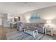Open-concept living room with a plush sectional, dining area, and modern decor at 5624 Palmer Cir # 206, Bradenton, FL 34211