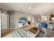 Bright living room featuring tile floors, a ceiling fan, and a large television at 5624 Palmer Cir # 206, Bradenton, FL 34211