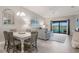 Inviting living room and dining area with sliding glass doors to a balcony overlooking a pond at 5624 Palmer Cir # 206, Bradenton, FL 34211