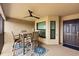 Relaxing screened patio with comfortable seating and ceiling fan. Entry door visible at 5624 Palmer Cir # 206, Bradenton, FL 34211