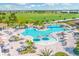 Resort-style pool area featuring waterfalls, lounge chairs, umbrellas, and lush landscaping at 5624 Palmer Cir # 206, Bradenton, FL 34211