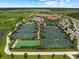 Aerial view showcasing multiple tennis courts, golf course, pool, and community amenities at 5624 Palmer Cir # 206, Bradenton, FL 34211