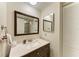 A bathroom with a dark wood vanity and large mirror at 6108 7Th W Ave # 6108, Bradenton, FL 34209