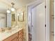 A bathroom with floral wallpaper featuring a wood vanity at 6108 7Th W Ave # 6108, Bradenton, FL 34209