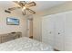 Neutral toned bedroom with a mounted TV, closet, and laminate floors at 6108 7Th W Ave # 6108, Bradenton, FL 34209