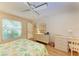 A bedroom features a ceiling fan, wood-look floors and neutral colored walls at 6108 7Th W Ave # 6108, Bradenton, FL 34209