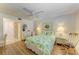 A charming bedroom features a floral-patterned bed, ceiling fan, and wood-look floors at 6108 7Th W Ave # 6108, Bradenton, FL 34209