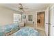 A bedroom with twin beds, a dresser, a window, and a mirrored closet at 6108 7Th W Ave # 6108, Bradenton, FL 34209