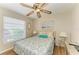 Cozy bedroom featuring a queen bed, wood-look floors, and a ceiling fan at 6108 7Th W Ave # 6108, Bradenton, FL 34209