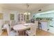 A dining room featuring an oval table and chairs, with a view to the kitchen at 6108 7Th W Ave # 6108, Bradenton, FL 34209