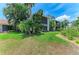 Beautiful exterior view of the condo with lush landscaping, mature palm trees, and screened-in balconies at 6108 7Th W Ave # 6108, Bradenton, FL 34209