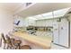 Well-lit kitchen featuring wooden countertops, ample storage, and modern appliances at 6108 7Th W Ave # 6108, Bradenton, FL 34209