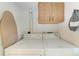 Convenient laundry room area with a washer, dryer, storage cabinet, and ironing board at 6108 7Th W Ave # 6108, Bradenton, FL 34209
