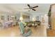 Comfortable living room adjacent to dining area with hardwood floors and ceiling fan at 6108 7Th W Ave # 6108, Bradenton, FL 34209