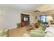 Cozy living room featuring a television, lounge chair and sliding glass door at 6108 7Th W Ave # 6108, Bradenton, FL 34209