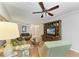 A living room with wood floors, ceiling fan and a floral-themed couch and chair at 6108 7Th W Ave # 6108, Bradenton, FL 34209