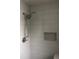 This bathroom features a tiled shower with updated fixtures and a built-in niche at 669 Spanish N Dr # 21, Longboat Key, FL 34228