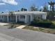 Inviting villa with tropical landscaping, a covered parking area and a warm, welcoming entrance at 669 Spanish N Dr # 21, Longboat Key, FL 34228