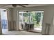 Renovation-ready living room with large sliding glass doors offering a view of the outdoor patio at 669 Spanish N Dr # 21, Longboat Key, FL 34228