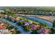 This aerial view captures a home on a golf course with a lake, surrounded by lush trees and manicured lawns at 6914 Dominion Ln, Lakewood Ranch, FL 34202