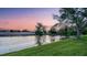 This lush backyard features mature shade trees and a tranquil pond at 6914 Dominion Ln, Lakewood Ranch, FL 34202