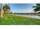 Lush green backyard view showcases mature trees and a pond at 6914 Dominion Ln, Lakewood Ranch, FL 34202