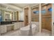 This luxurious bathroom features a soaking tub, walk-in shower, and dual vanities with granite countertops at 6914 Dominion Ln, Lakewood Ranch, FL 34202