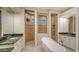 This luxurious bathroom features a soaking tub, walk-in shower, and dual vanities with granite countertops at 6914 Dominion Ln, Lakewood Ranch, FL 34202