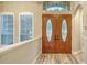 Elegant entryway featuring double doors with decorative glass and transom window offering plenty of natural light at 6914 Dominion Ln, Lakewood Ranch, FL 34202