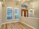 Bright entryway featuring wood-look floors, a chandelier, and double doors with decorative windows at 6914 Dominion Ln, Lakewood Ranch, FL 34202