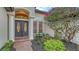 Inviting front entrance featuring a double door, decorative sidelights, and lush landscaping at 6914 Dominion Ln, Lakewood Ranch, FL 34202