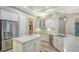 Stylish kitchen with white cabinets, stainless steel appliances, island and breakfast bar at 6914 Dominion Ln, Lakewood Ranch, FL 34202