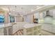 Spacious kitchen with island, breakfast bar, stainless appliances, and wood floors at 6914 Dominion Ln, Lakewood Ranch, FL 34202