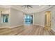 Spacious living room with wood floors, tray ceiling, and view of the pool at 6914 Dominion Ln, Lakewood Ranch, FL 34202