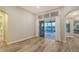 A spacious living room features a large sliding glass door with views of the pool and outdoor scenery at 6914 Dominion Ln, Lakewood Ranch, FL 34202