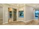 Bright living room with wood floors and large windows overlooking the outdoor pool at 6914 Dominion Ln, Lakewood Ranch, FL 34202