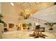 Inviting grand lobby with a staircase, decorative plants, and elegant decor at 6914 Dominion Ln, Lakewood Ranch, FL 34202
