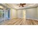 Large main bedroom with tray ceilings, hardwood floors, and access to both the bathroom and patio at 6914 Dominion Ln, Lakewood Ranch, FL 34202