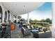Stylish outdoor seating area with views of a scenic garden, lake, and landscaped lawn at 6914 Dominion Ln, Lakewood Ranch, FL 34202