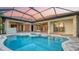 Beautiful pool and spa surrounded by a covered patio with multiple access points at 6914 Dominion Ln, Lakewood Ranch, FL 34202