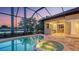 Inviting screened pool and spa with outdoor kitchen and stunning lake views at 6914 Dominion Ln, Lakewood Ranch, FL 34202