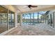 This covered patio features a large in-ground pool and jacuzzi with brick pavers and serene outdoor views at 6914 Dominion Ln, Lakewood Ranch, FL 34202