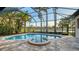 Beautiful screened pool and spa with a picturesque lake view during daylight at 6914 Dominion Ln, Lakewood Ranch, FL 34202