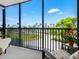 Relaxing balcony view with palm trees, landscaping, and a glimpse of the water at 707 S Gulfstream Ave # 301, Sarasota, FL 34236