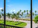Stunning balcony view overlooking lush tropical landscaping and Sarasota Bay beyond at 707 S Gulfstream Ave # 301, Sarasota, FL 34236