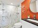 Modern bathroom with a marble tiled shower, granite countertop, and decorative starfish accents at 707 S Gulfstream Ave # 301, Sarasota, FL 34236